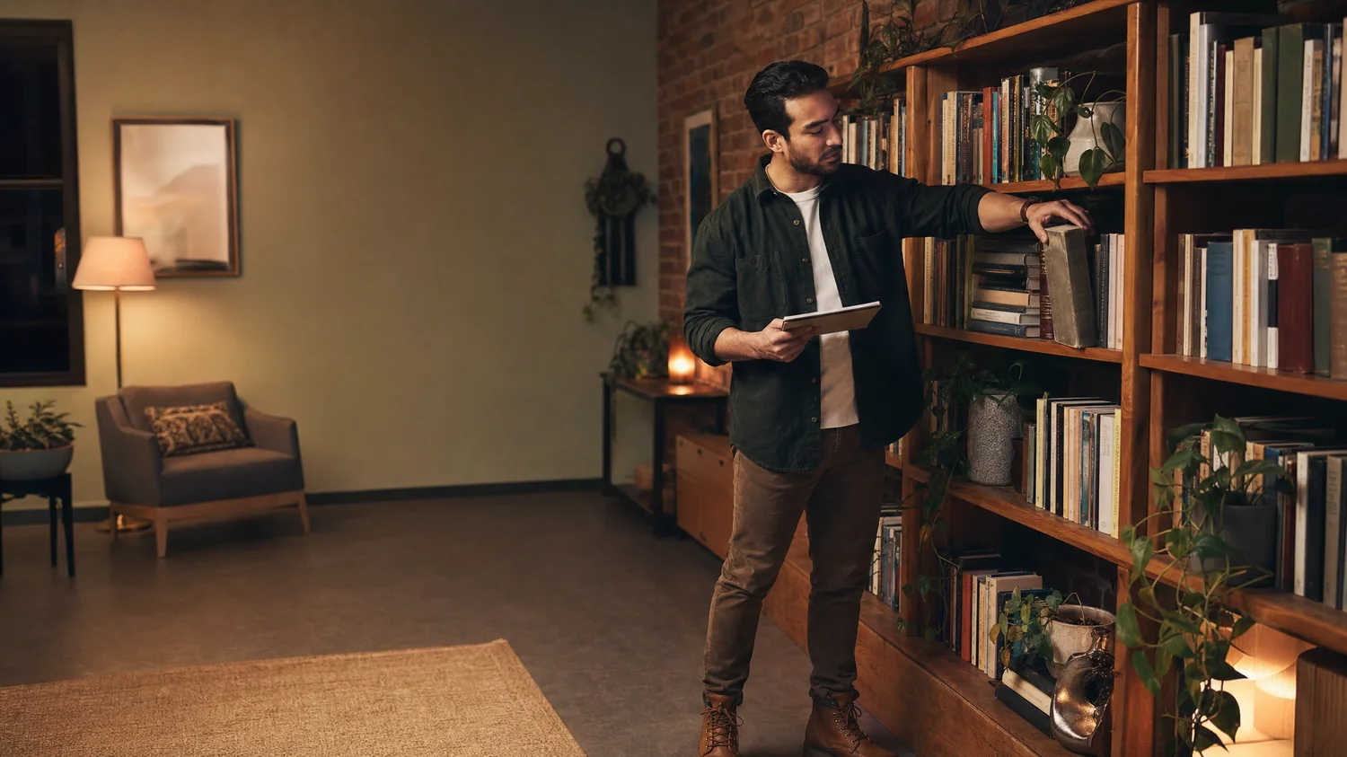 A Hispanic / Latino person, a therapist in a warm consulting office, sliding a well-worn reference book back onto a crowded shelf while glancing