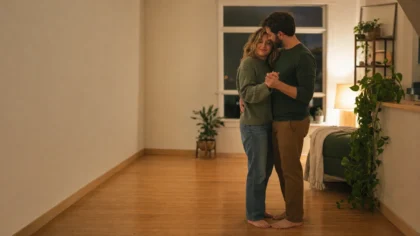 A white / Caucasian couple (one woman, one man) slow-dancing barefoot in a softly lit living room — Is It Okay to Plan Intimacy? 5 More Relationship Myths Therapists Want You to Rethink
